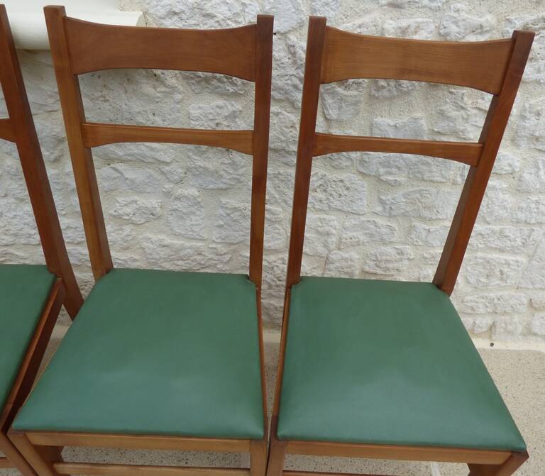 6 modern chairs with banded backs and green faux leather seats