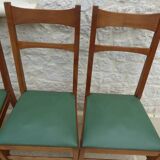 6 modern chairs with banded backs and green faux leather seats