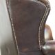 Chesterfield wing chair in dark brown leather with a luxurious appearance