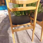 3 Scandinavian style chairs, light wood and black faux leather.