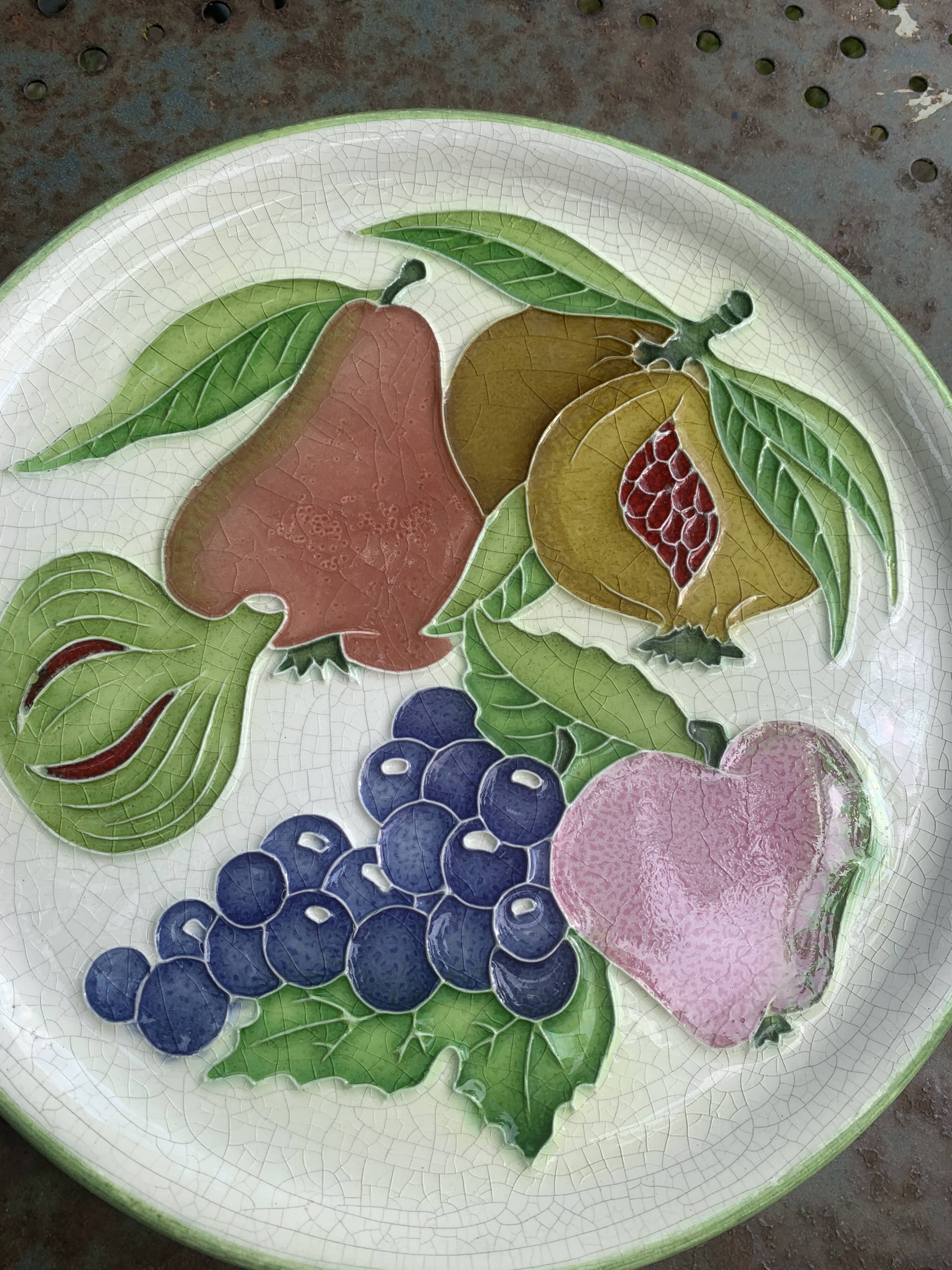Decorative plate to hang, fruit model, in enamelled ceramic, Les Fruits, signed Luciano