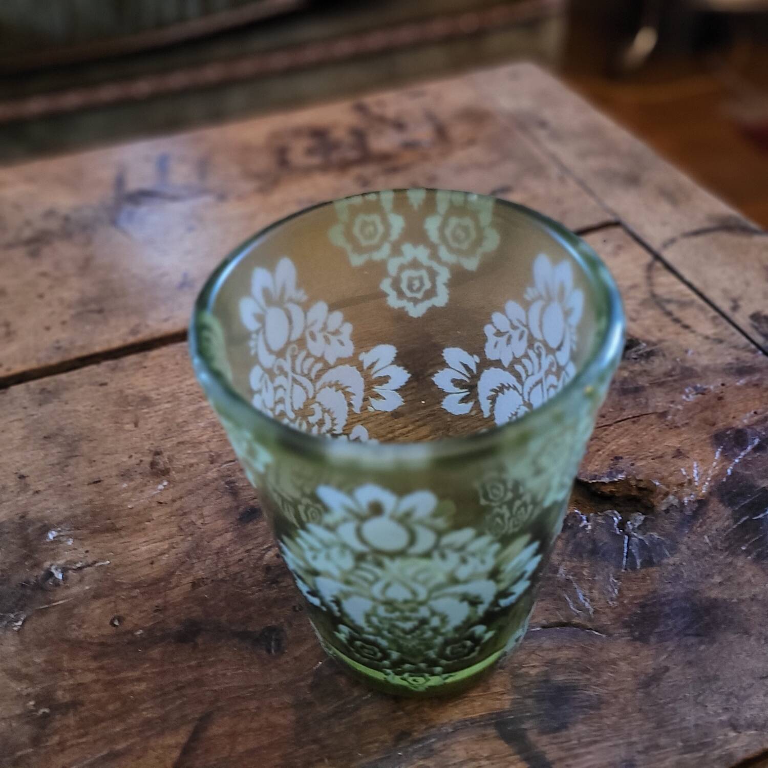 Green gradient blown glass vase with engraved floral decoration.