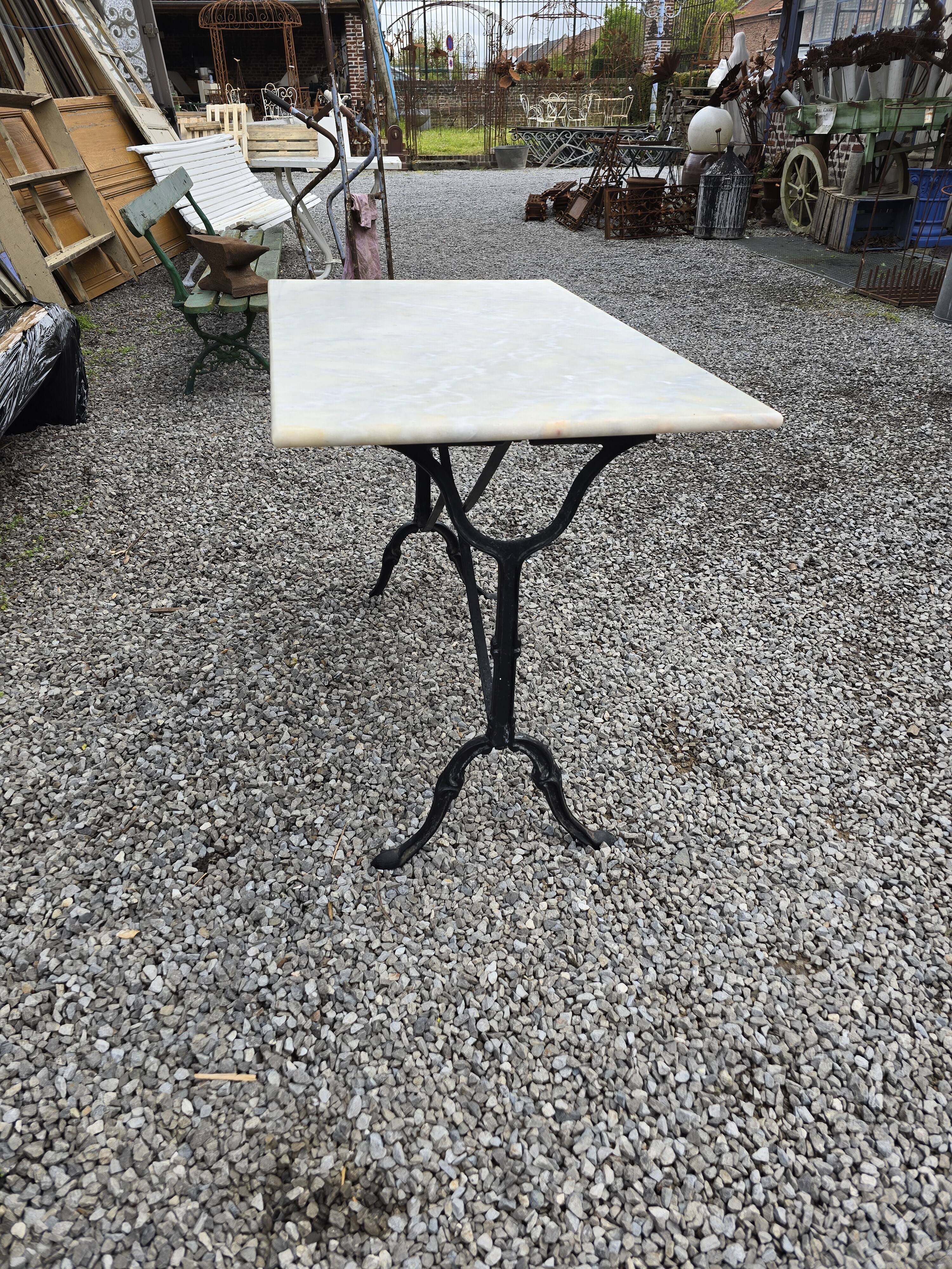 Bistro table with marble top and cast iron base