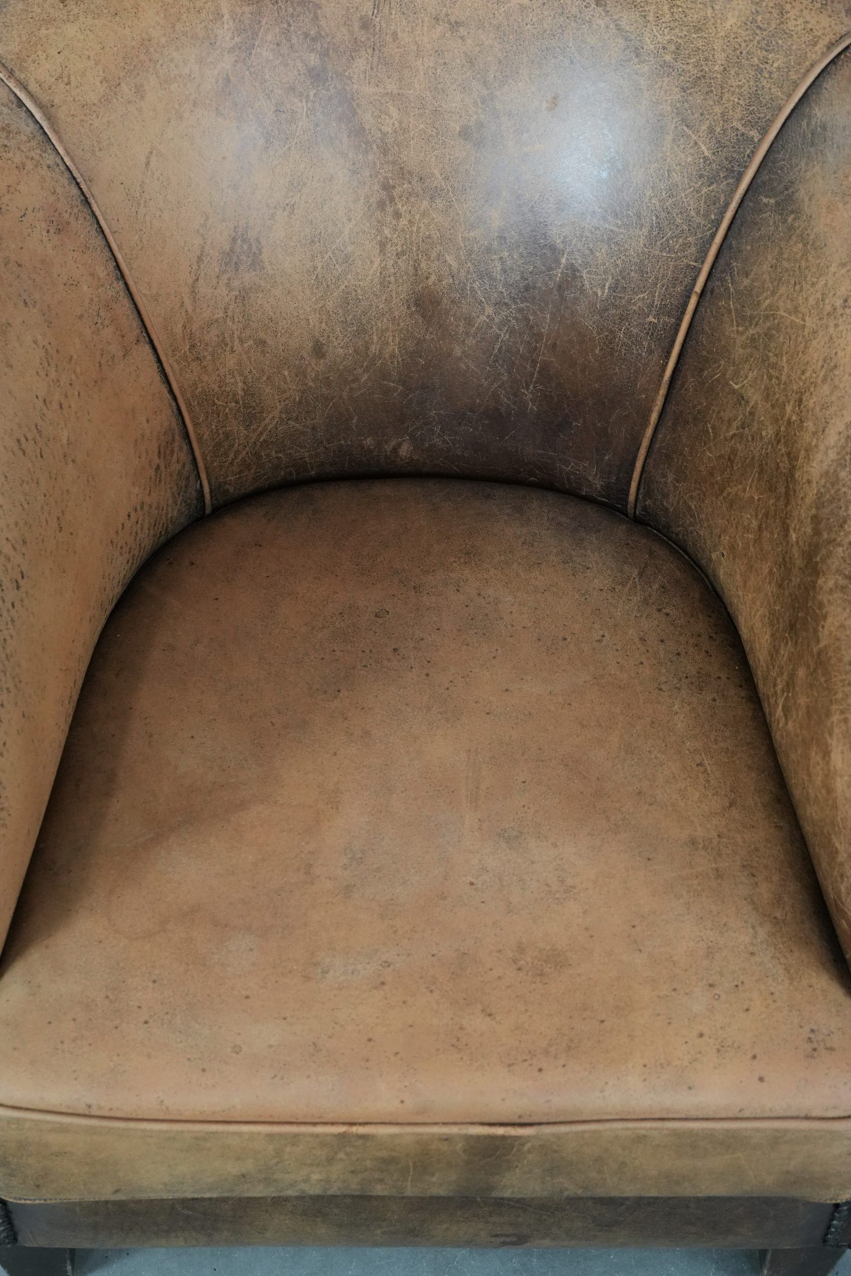 Vintage sheepskin club armchair with character and a beautiful patina