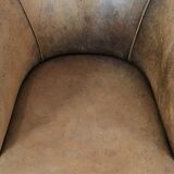 Vintage sheepskin club armchair with character and a beautiful patina