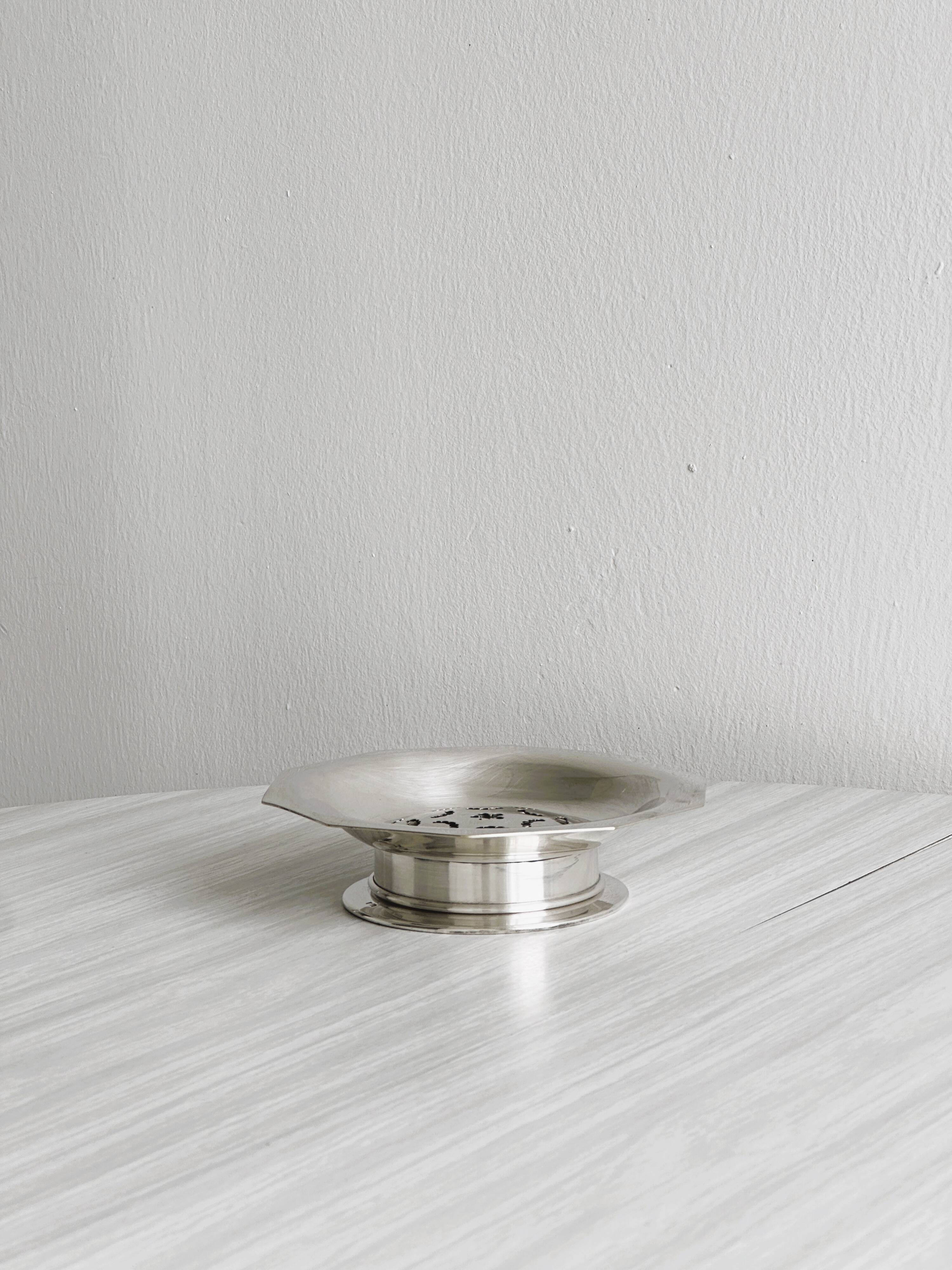 Antique butter dish in shiny metal