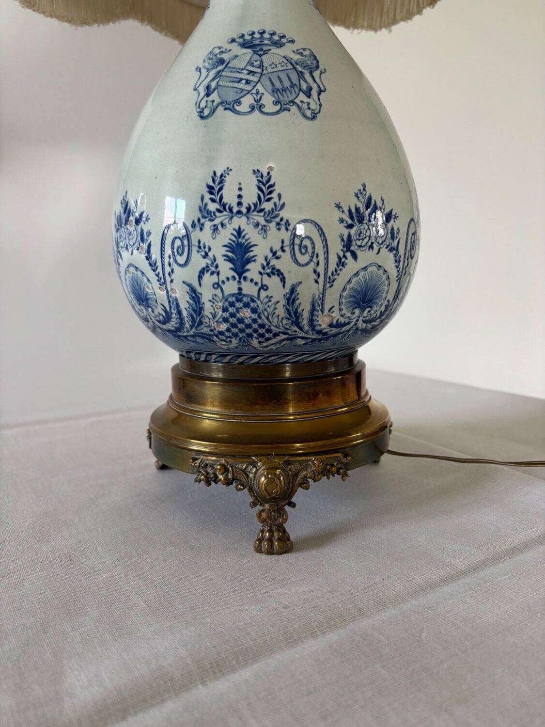 19th-century blue grand feu faience lamp, tripod bronze, fringed lampshade.