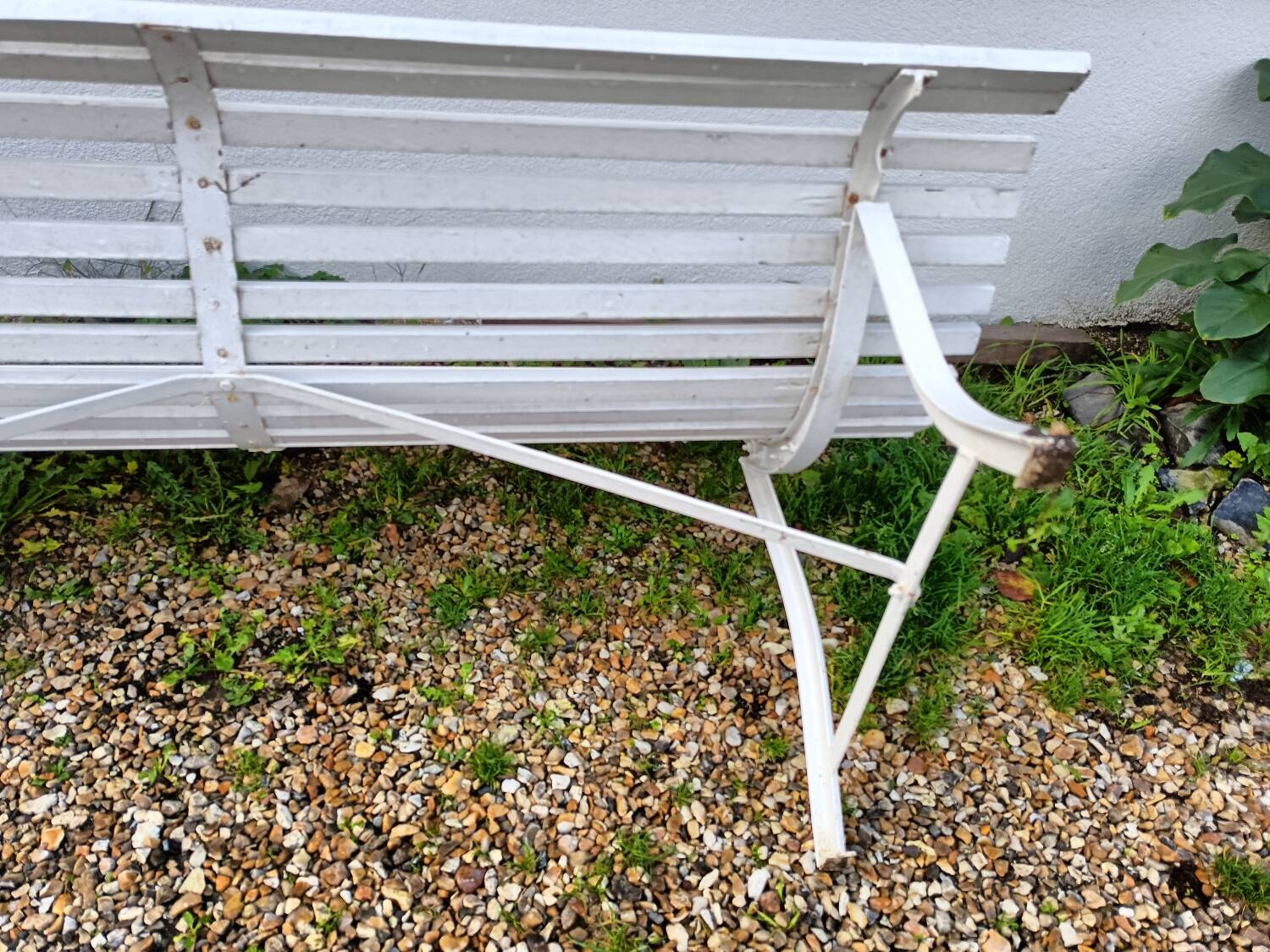 Old garden bench with metal legs and wooden slats
