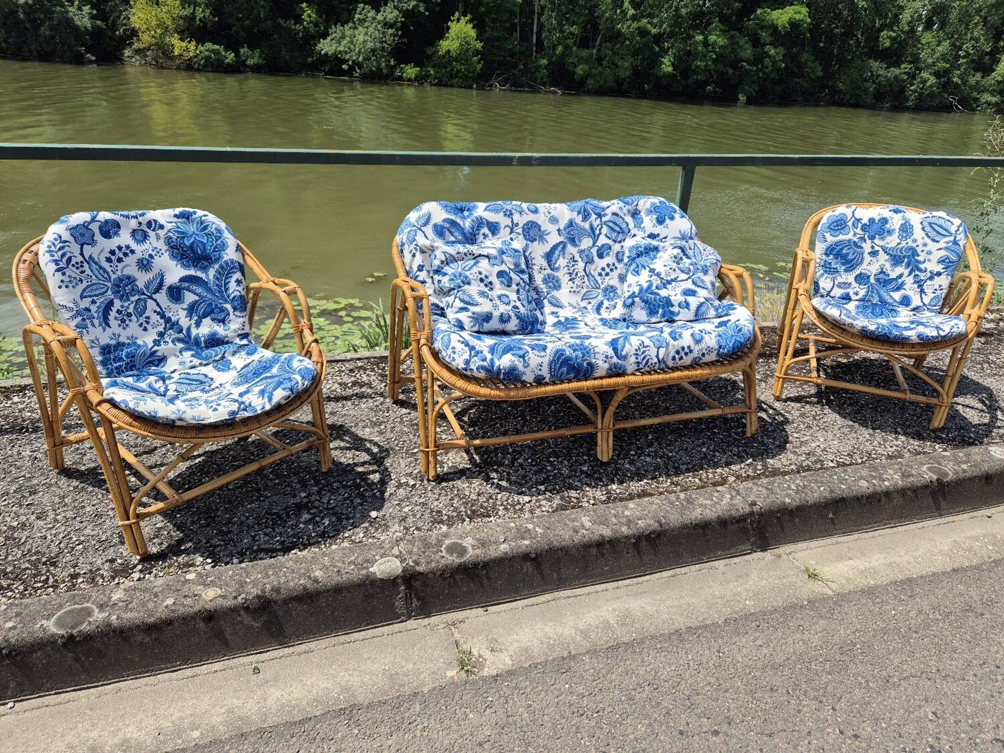 Rattan lounge with two armchairs and a vintage 1950s bench.