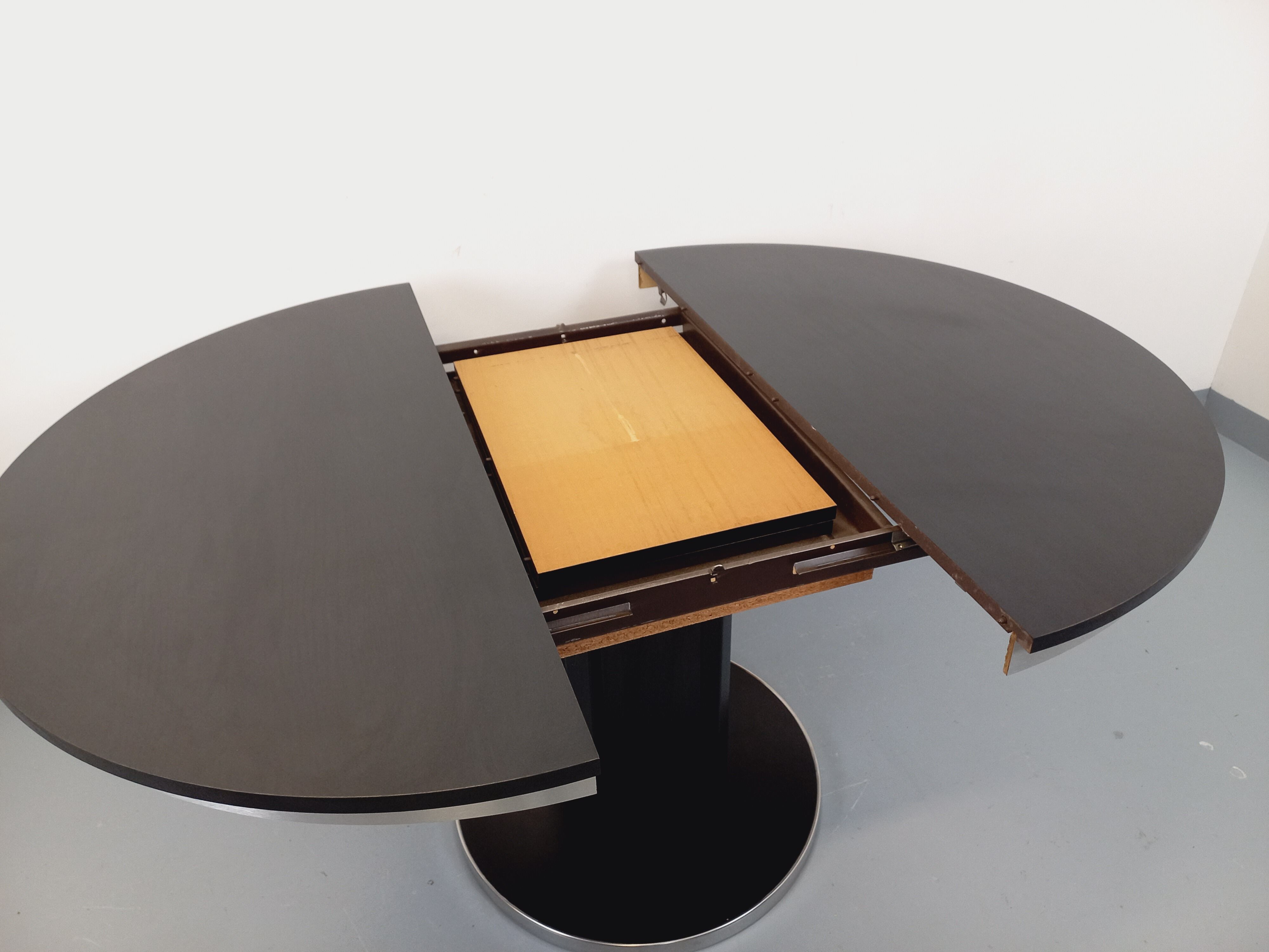 Vintage dining table in melamine with a black wood effect and chrome metal.