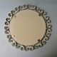 Round mirror with golden metal arabesques