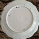 Large hand-painted French faience plate with floral decoration in folk art style.