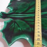 empty green ceramic pocket cup, small chips on the edges, signed