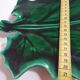 empty green ceramic pocket cup, small chips on the edges, signed