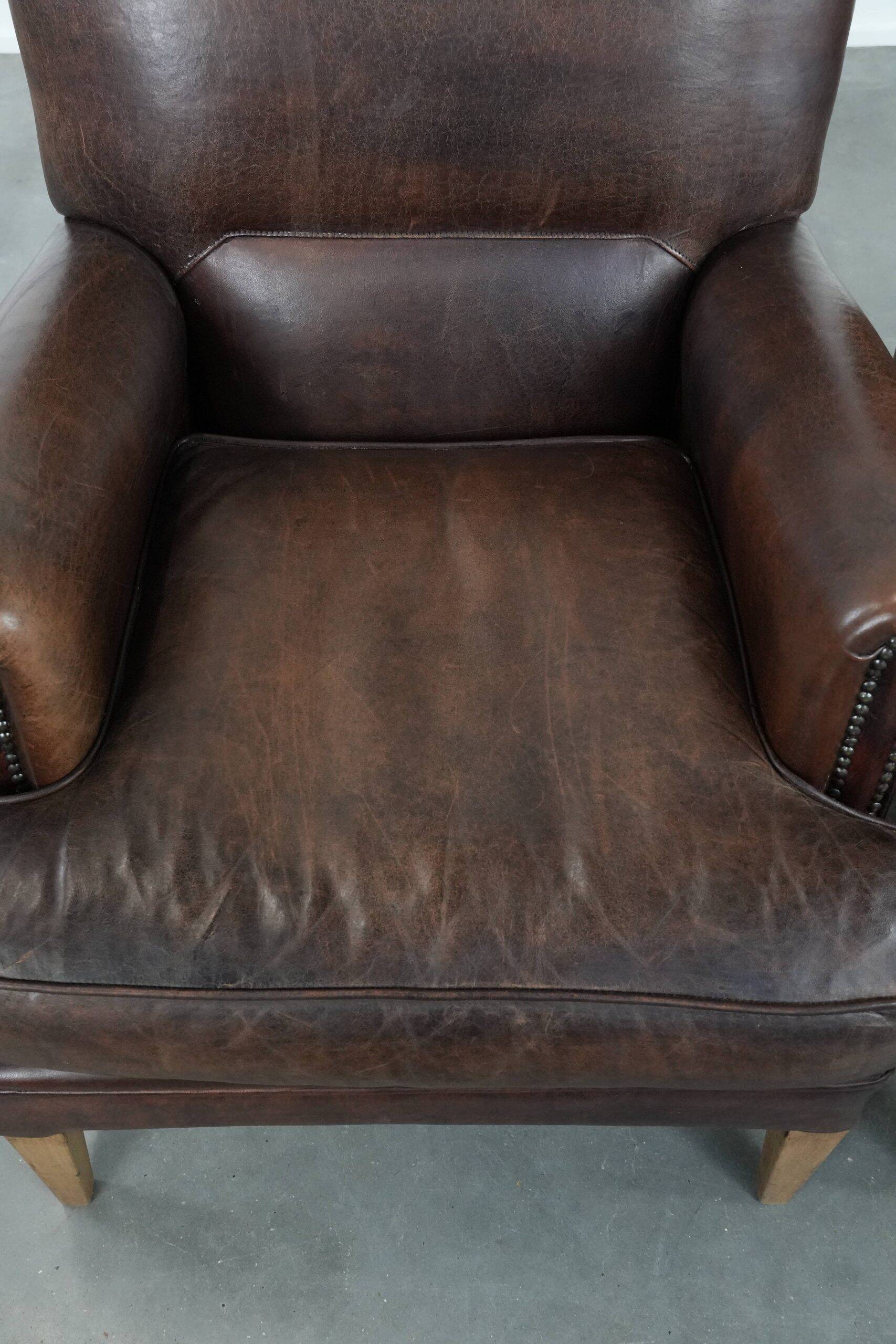 Set of two characterful sheepskin armchairs with a beautiful deep colour