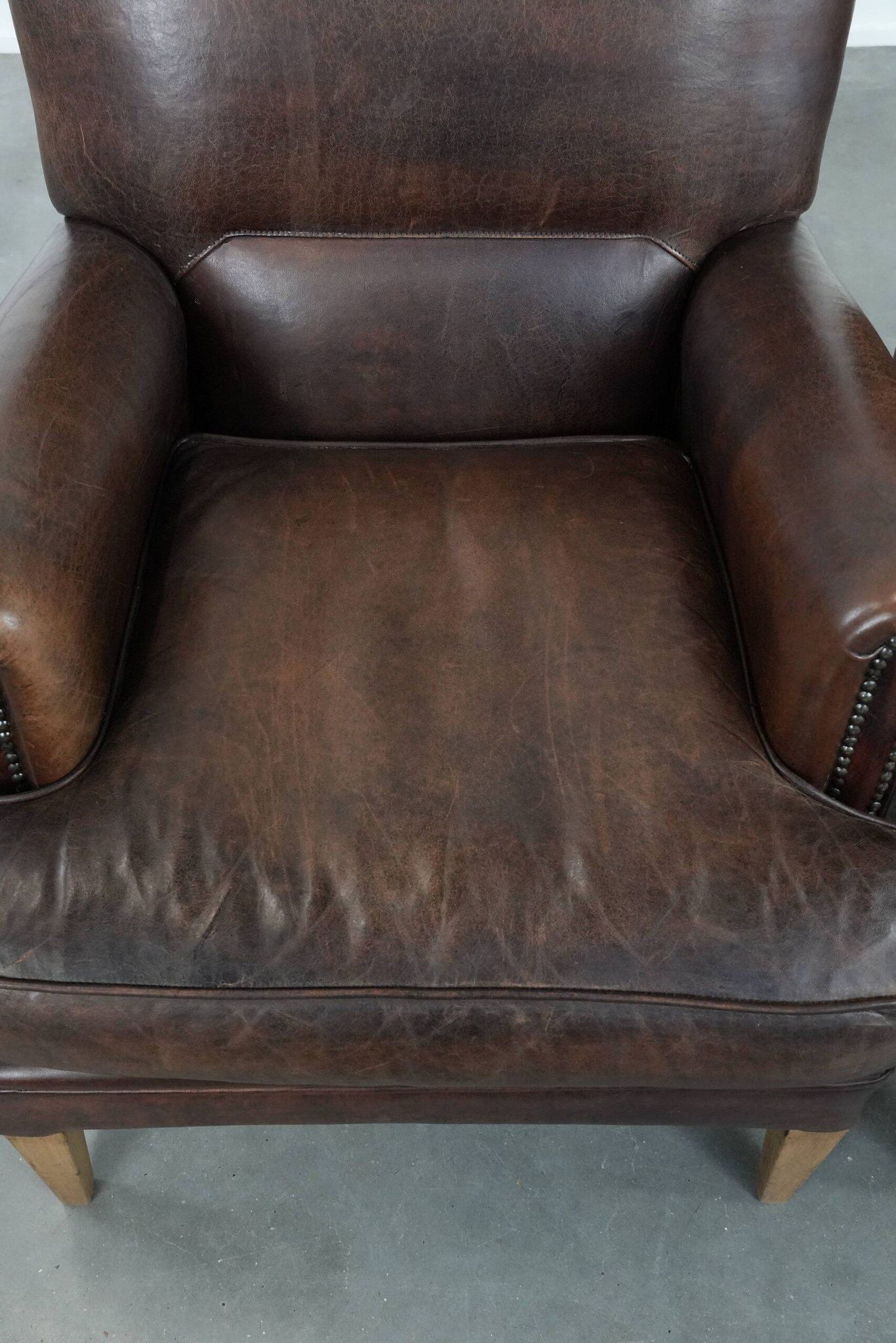Set of two characterful sheepskin armchairs with a beautiful deep colour
