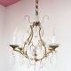 Old French chandelier in gilded brass with tassels