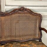 Grande banquette Louis XV en bois naturel mouluré et sculpté, France XVIIIème siècle