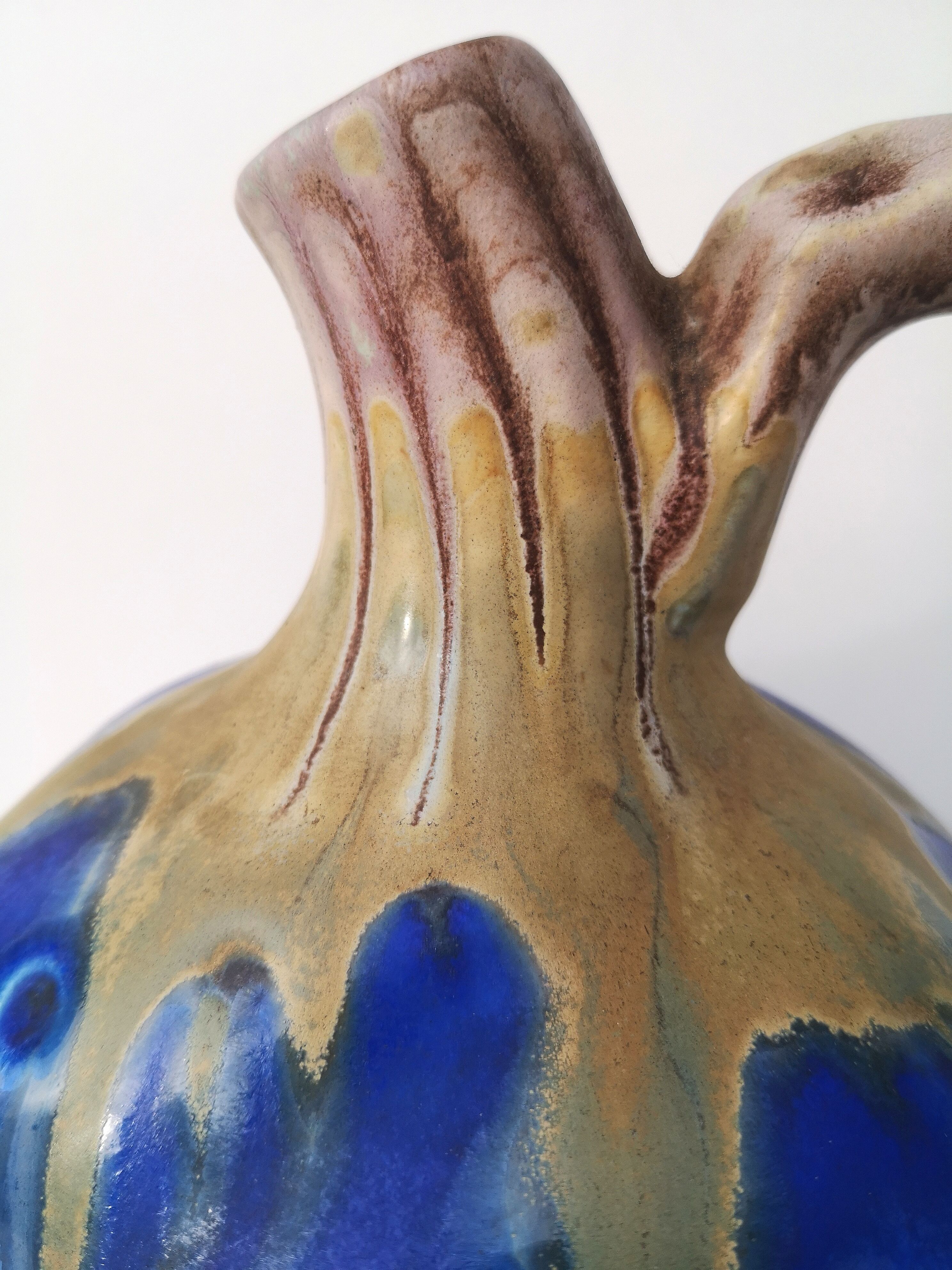 Vintage decanter in enamelled earthenware