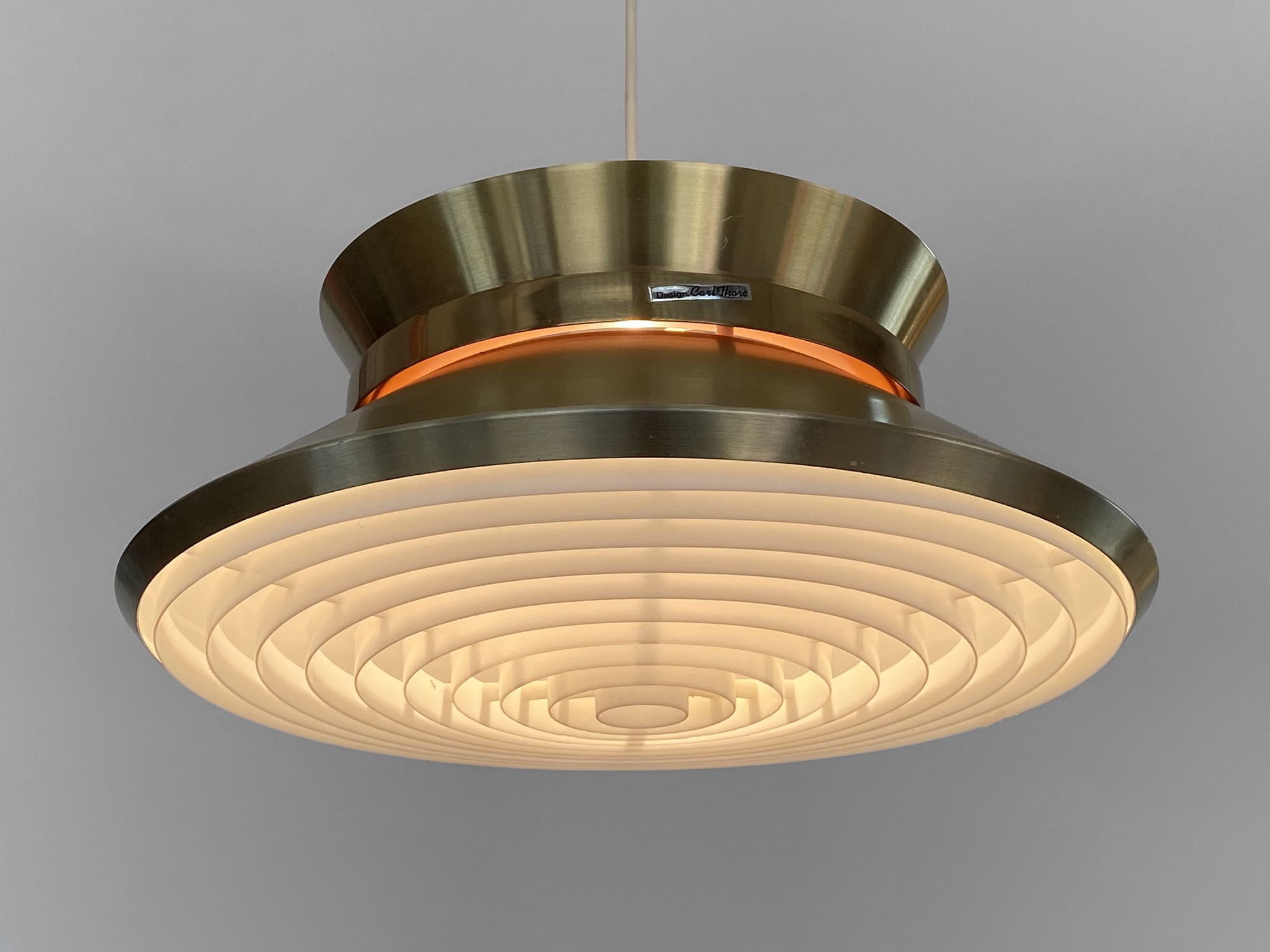Brass colored aluminium pendant light by Carl Thore for Granhaga Metall. Sweden 1970s.