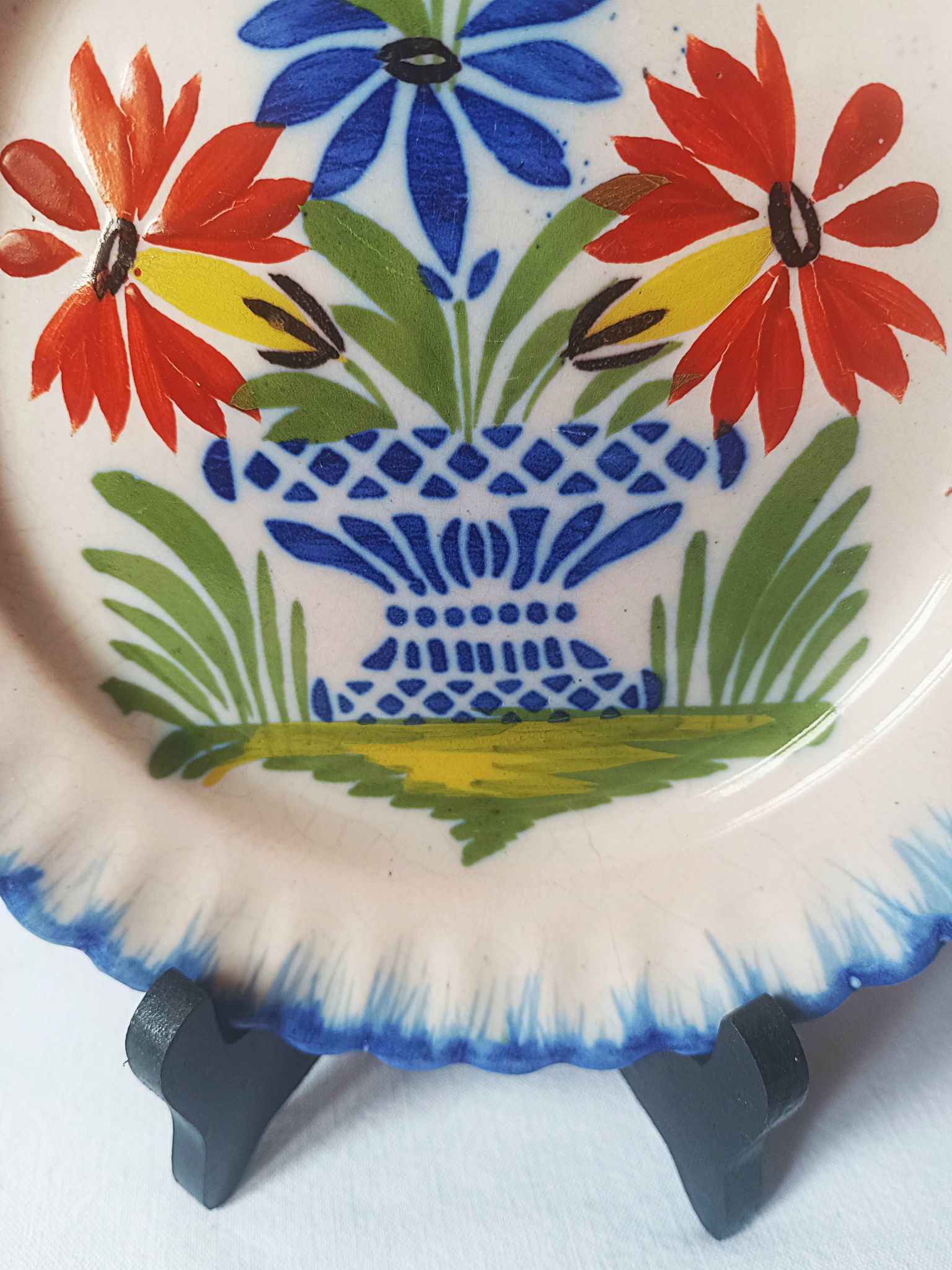 Pair of antique plates in popular earthenware with a floral basket decoration on the edge.