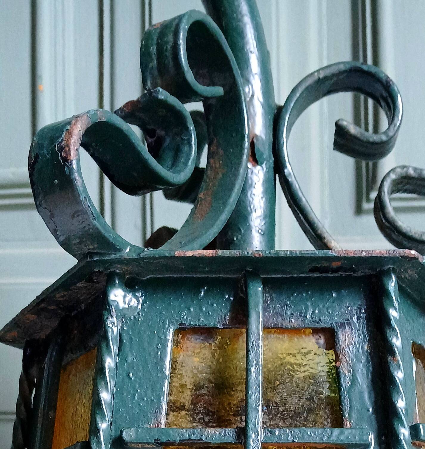 Wrought iron wall lantern & amber cathedral glass