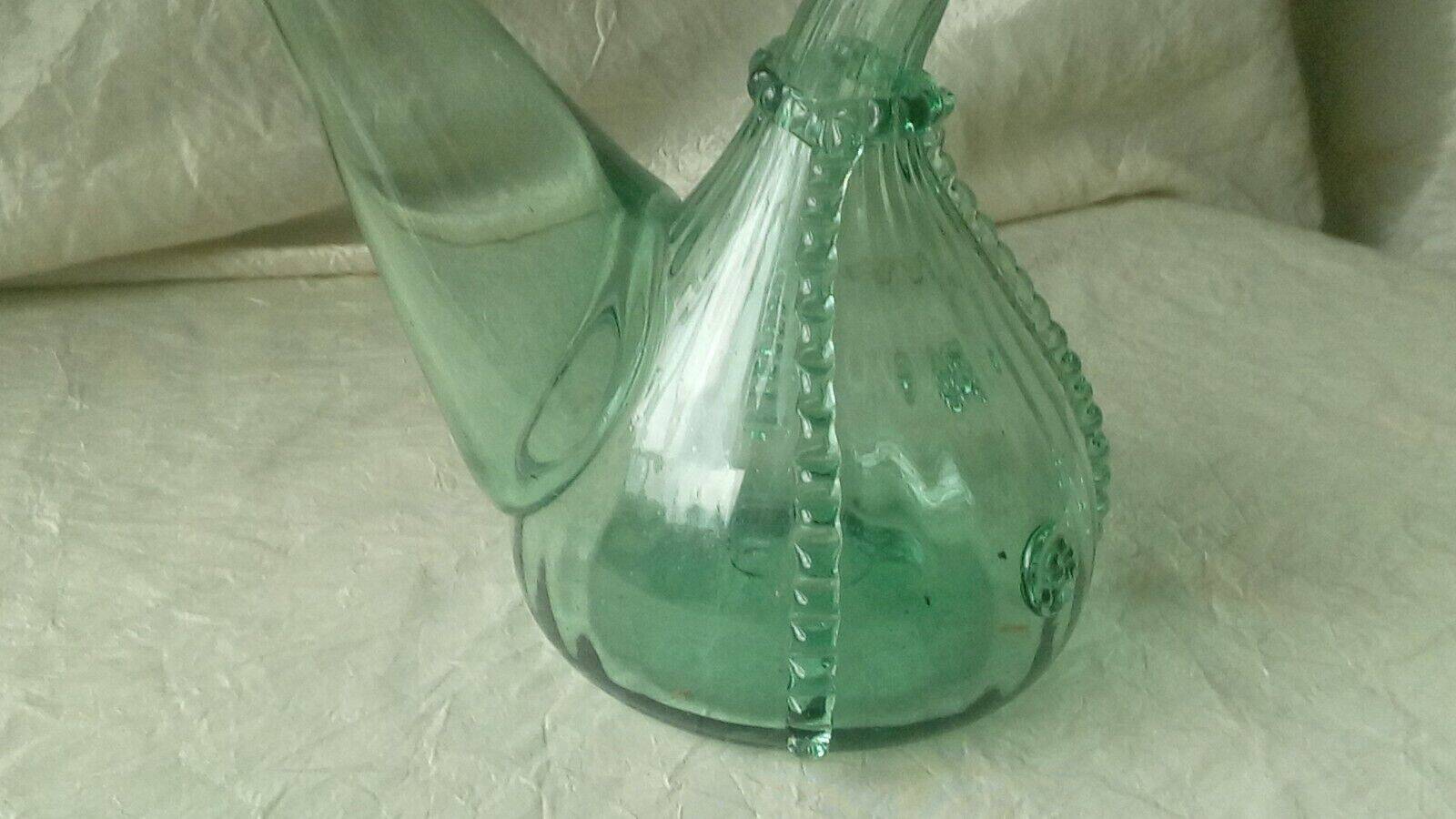 Blown glass carafe with a goat design.