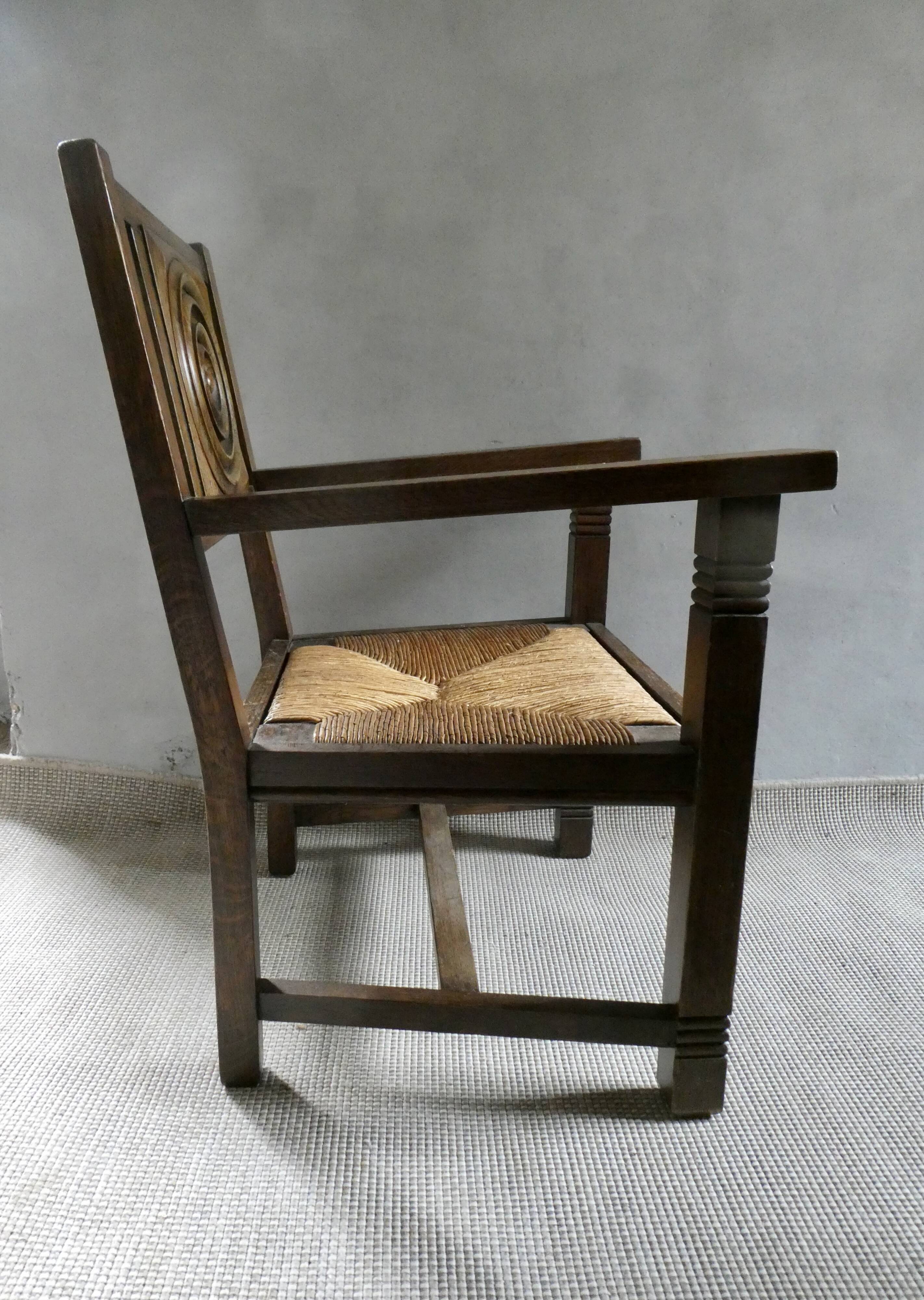 Armchair in carved solid wood with straw seat