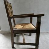 Armchair in carved solid wood with straw seat