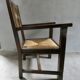 Armchair in carved solid wood with straw seat