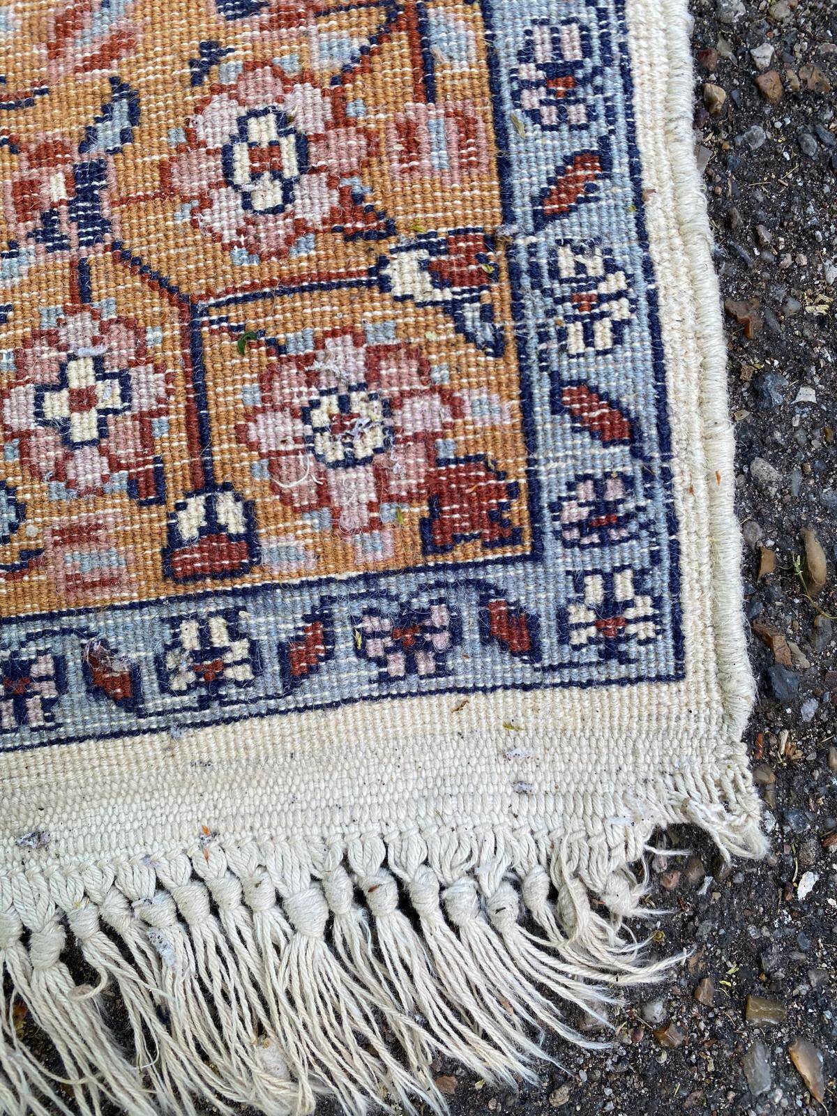 Handmade Persian rug in blue, beige, burgundy, and orange, 95x160cm.