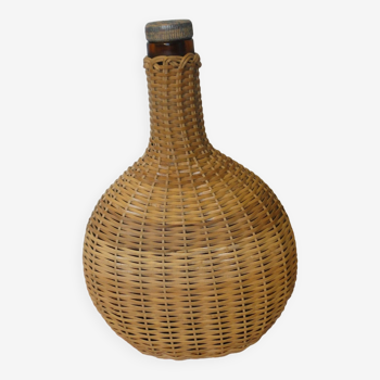 Flat bottle covered with vintage wicker