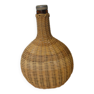 Flat bottle covered with vintage wicker