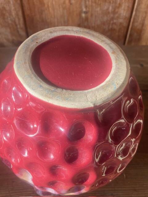 Old pitcher in burgundy ceramic
