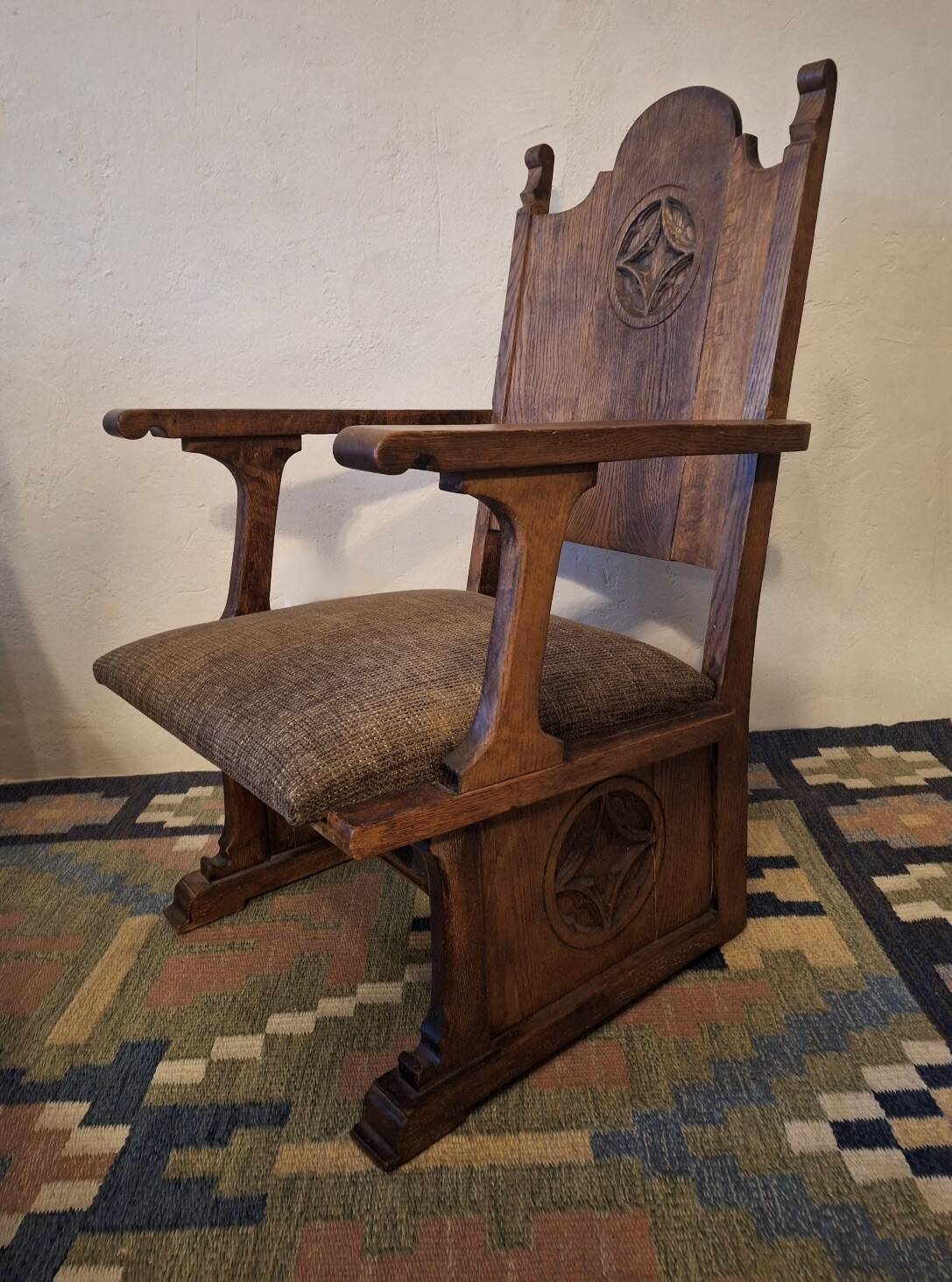 Antique Gothic Revival carved oak armchair, 1910