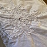 White tablecloth in fine embroidered white cotton.