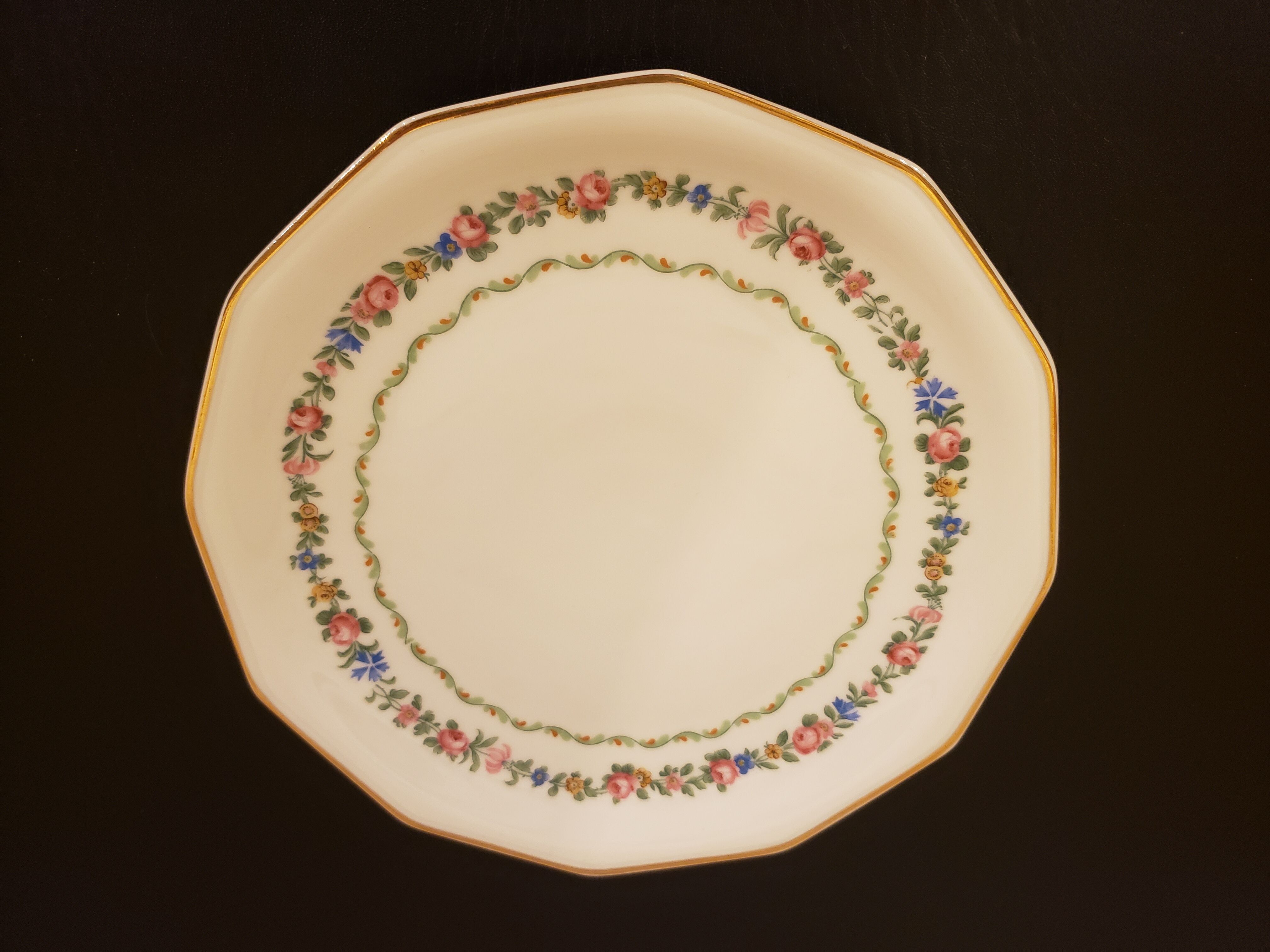 11 porcelain plates 12 sides bordered small flowers