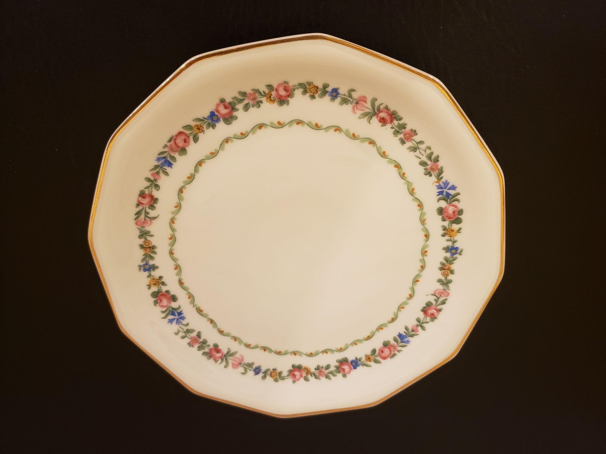 11 porcelain plates 12 sides bordered small flowers