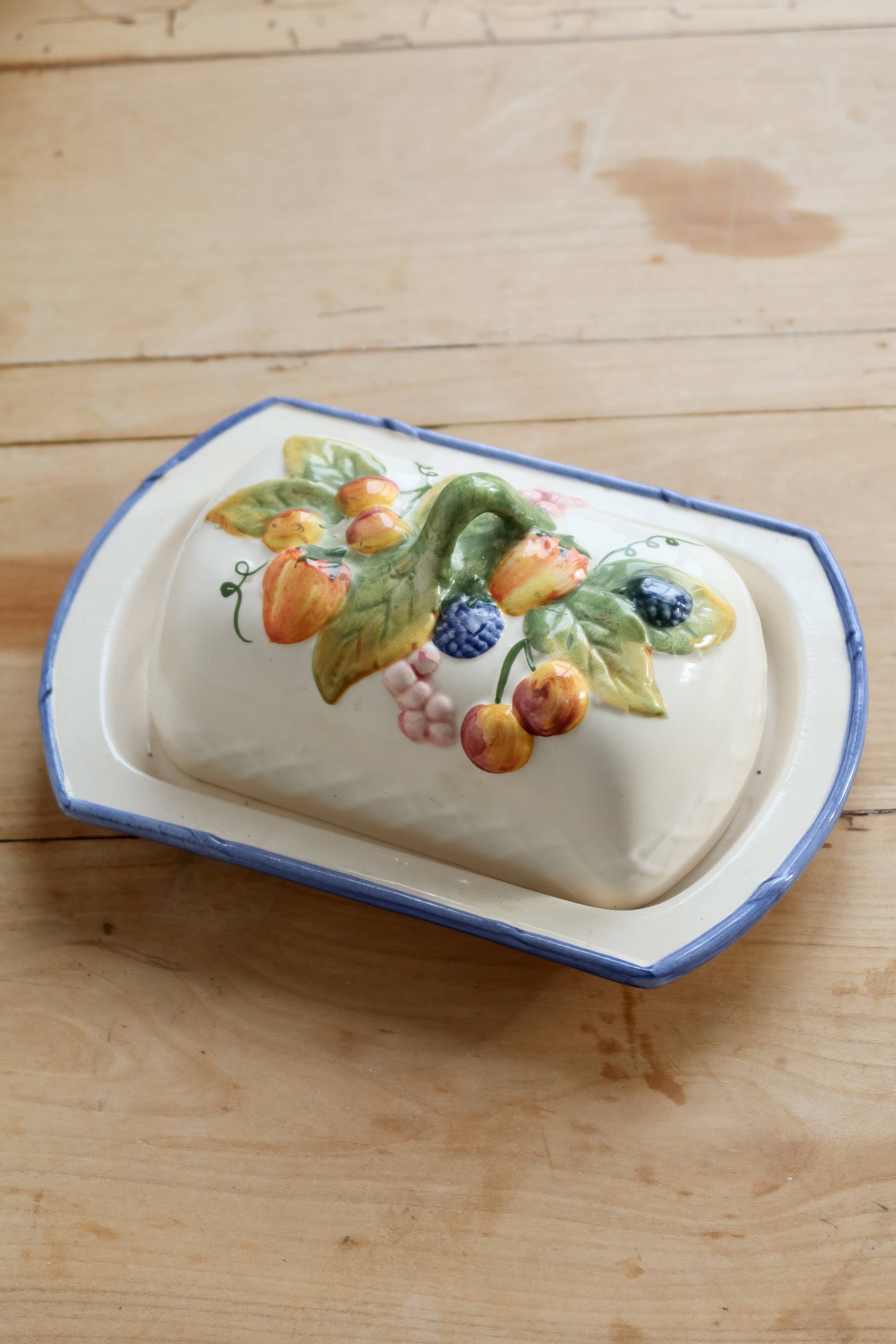 Large vintage faience butter dish with slip decoration – Fruit design