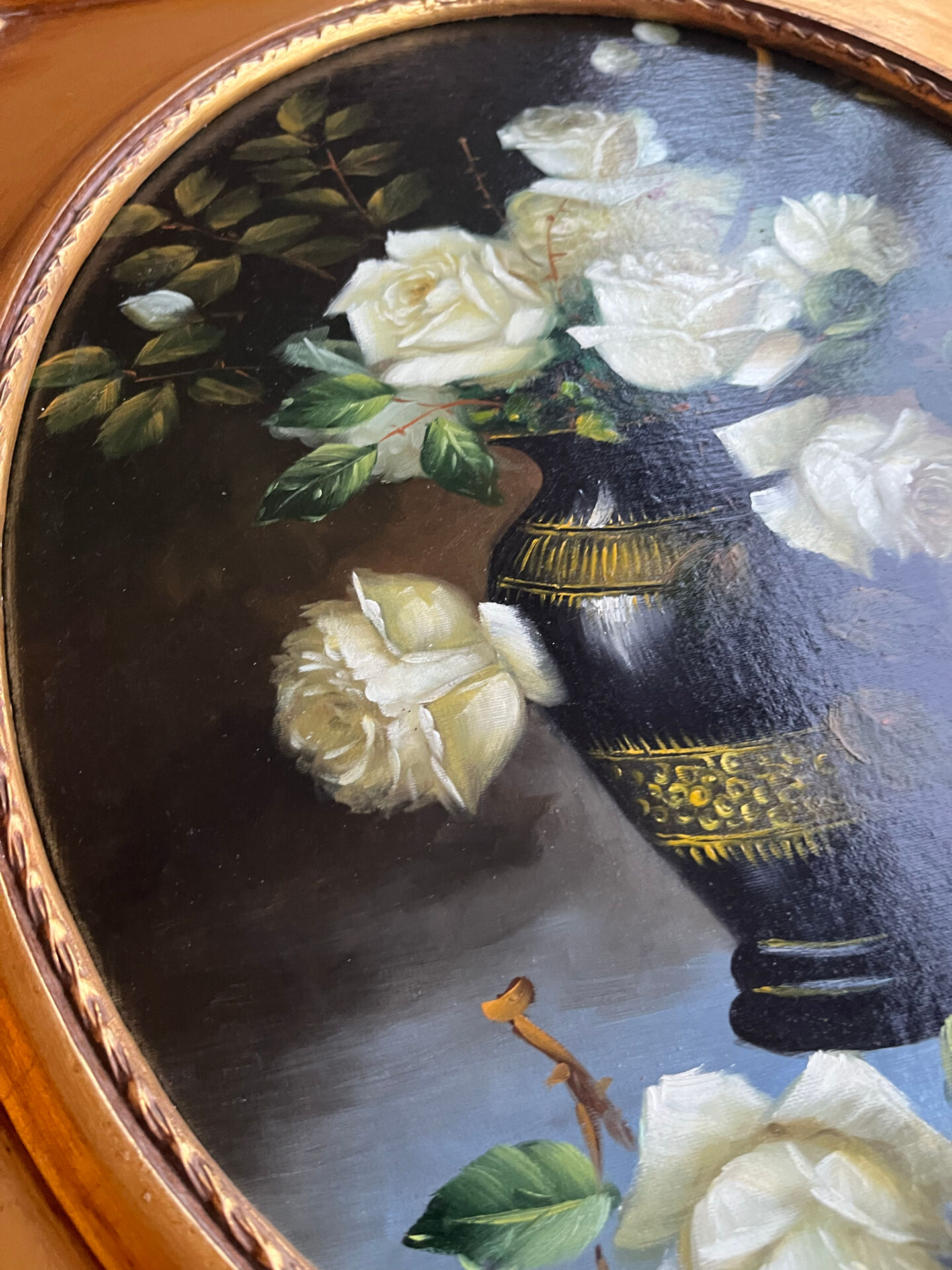 Large still life with white roses in an old gilded oval frame.