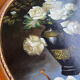 Large still life with white roses in an old gilded oval frame.