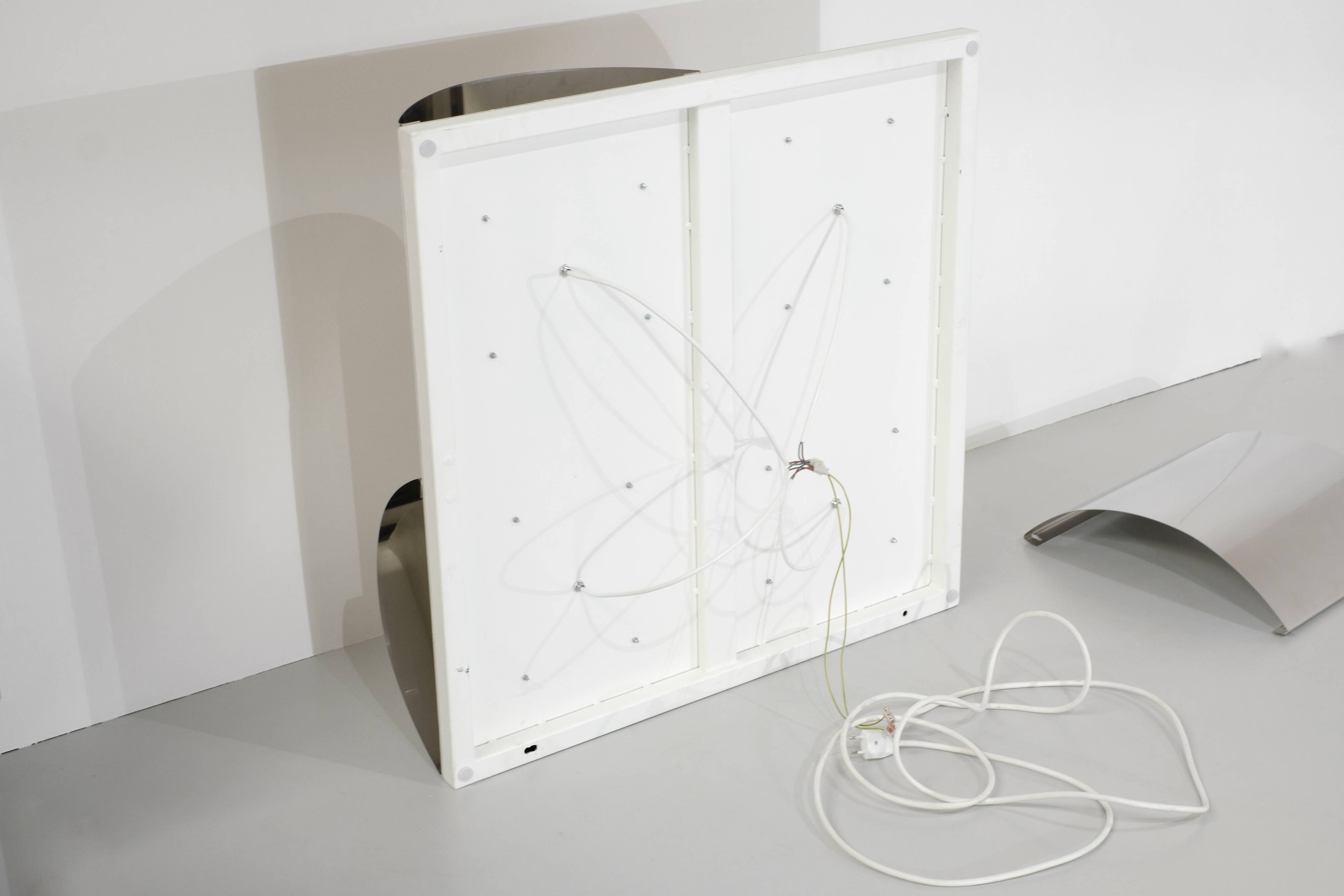 Contemporary wall light in stainless steel and metal.
