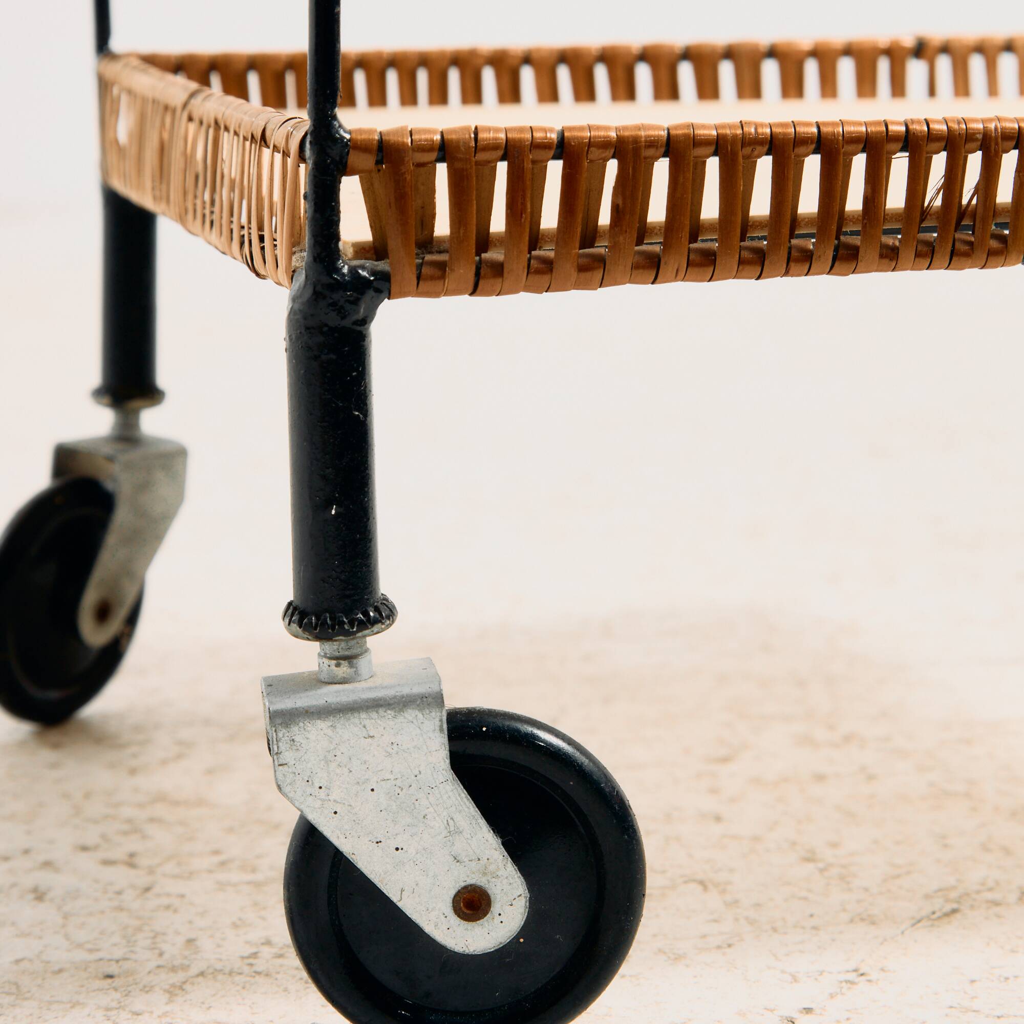 Metal cart with bamboo and wicker details.