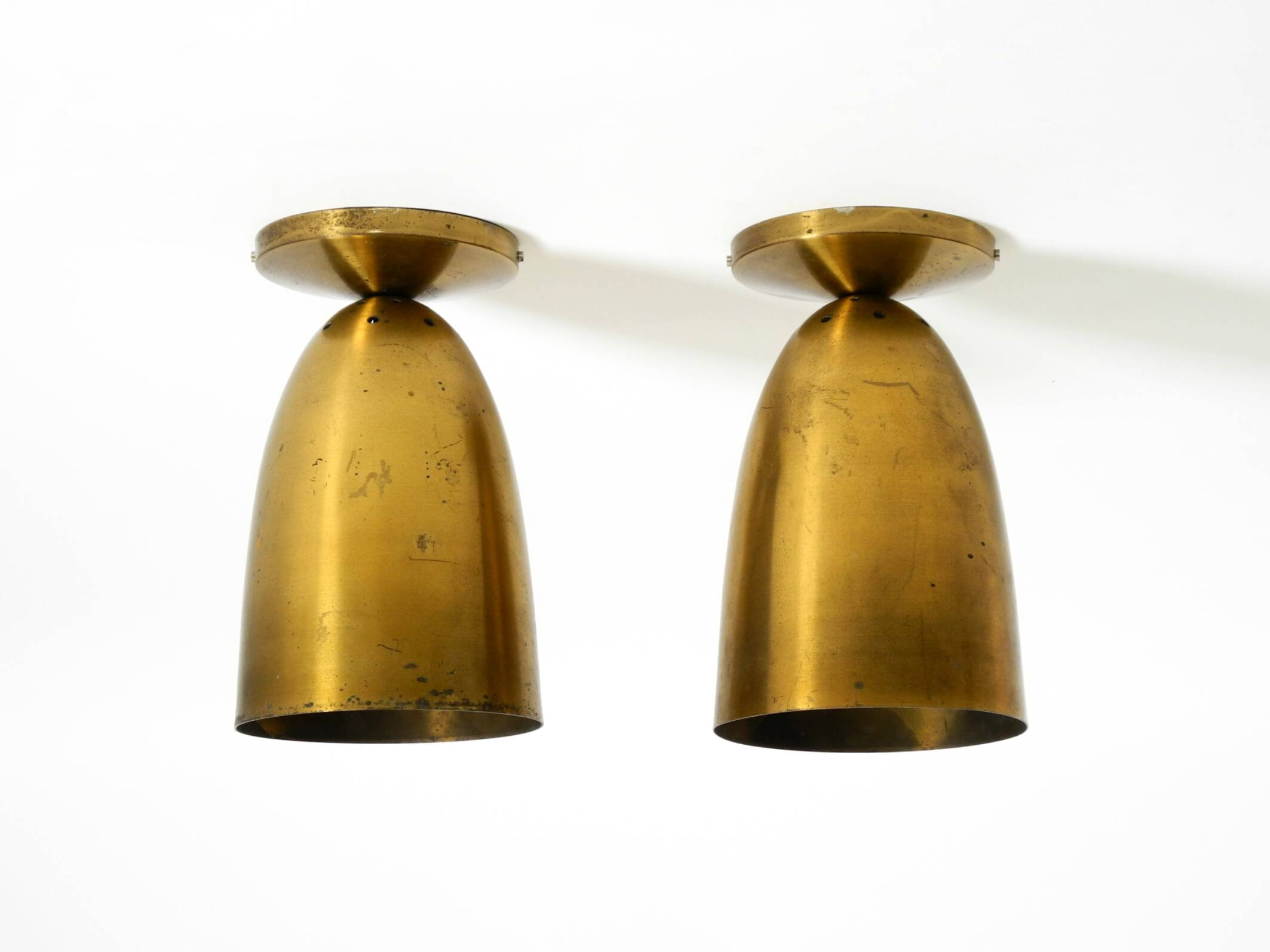 A pair of large, original Mid Century Modern brass ceiling lamps