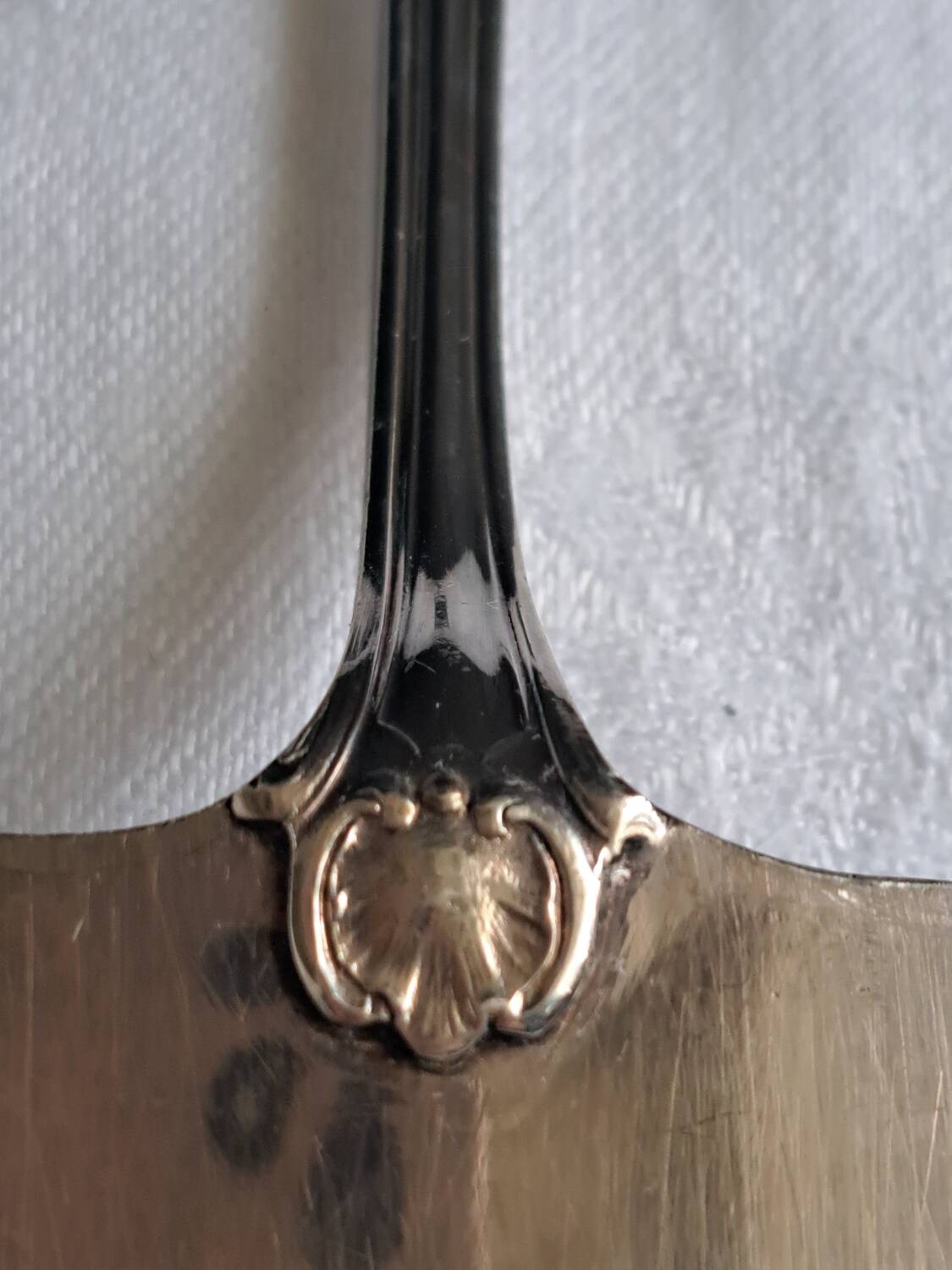 Silver metal cake peeler.