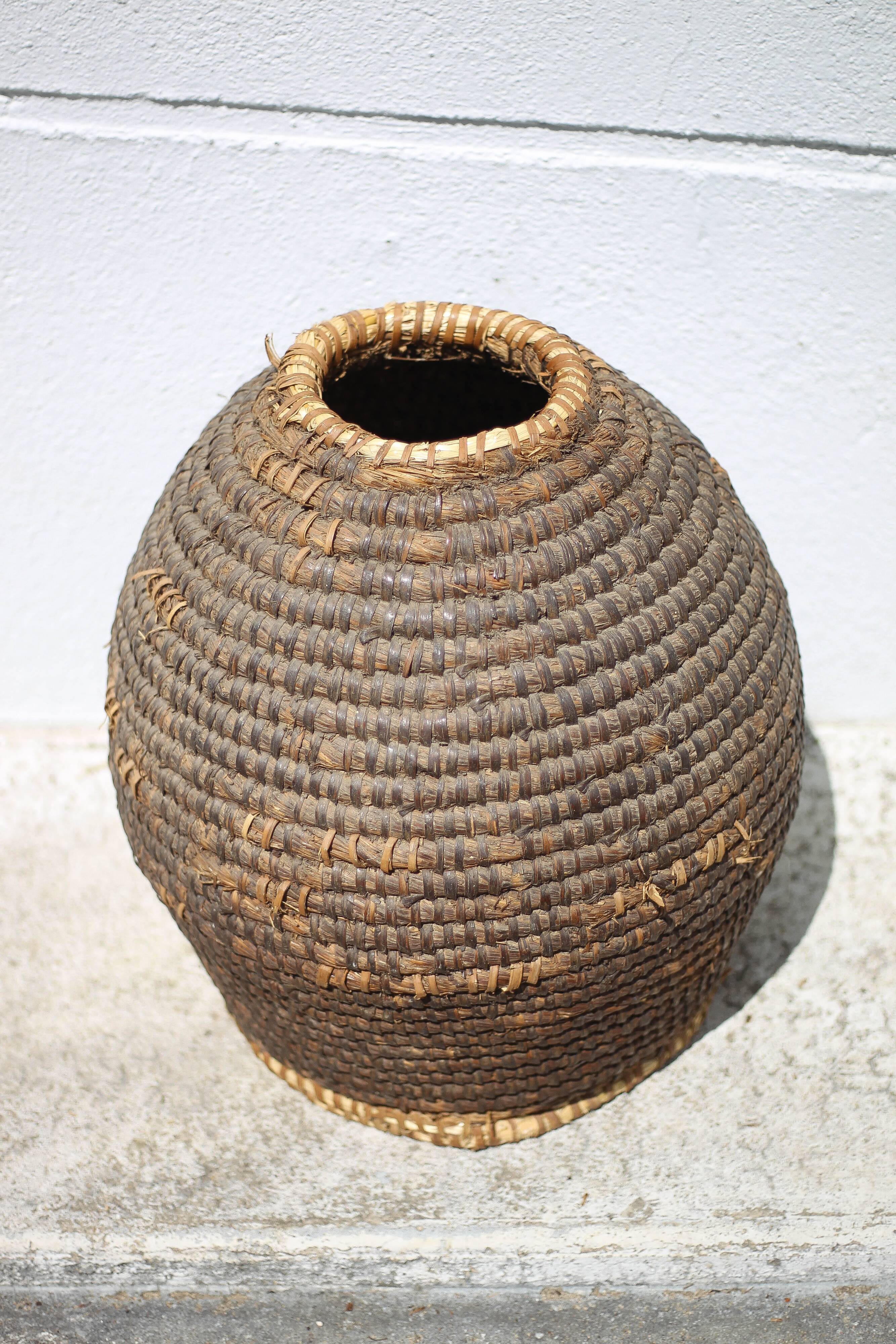 Old basket, burgundy straw and bramble, woven basket, interior decoration, pantry, flowerpot