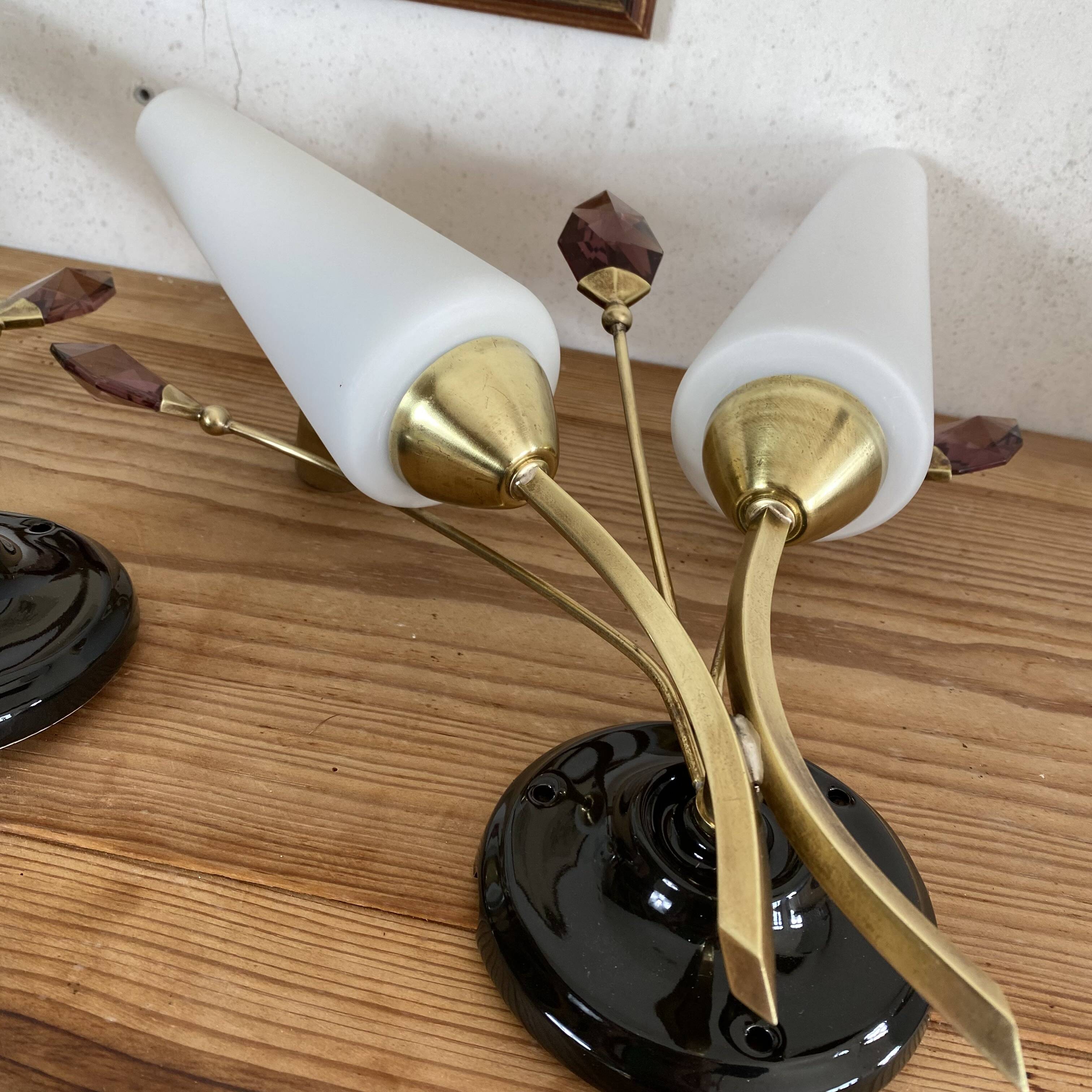 Pair of wall sconces in brass with white glass tulips.