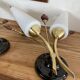 Pair of wall sconces in brass with white glass tulips.