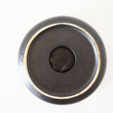 Empty round pocket in black ceramic