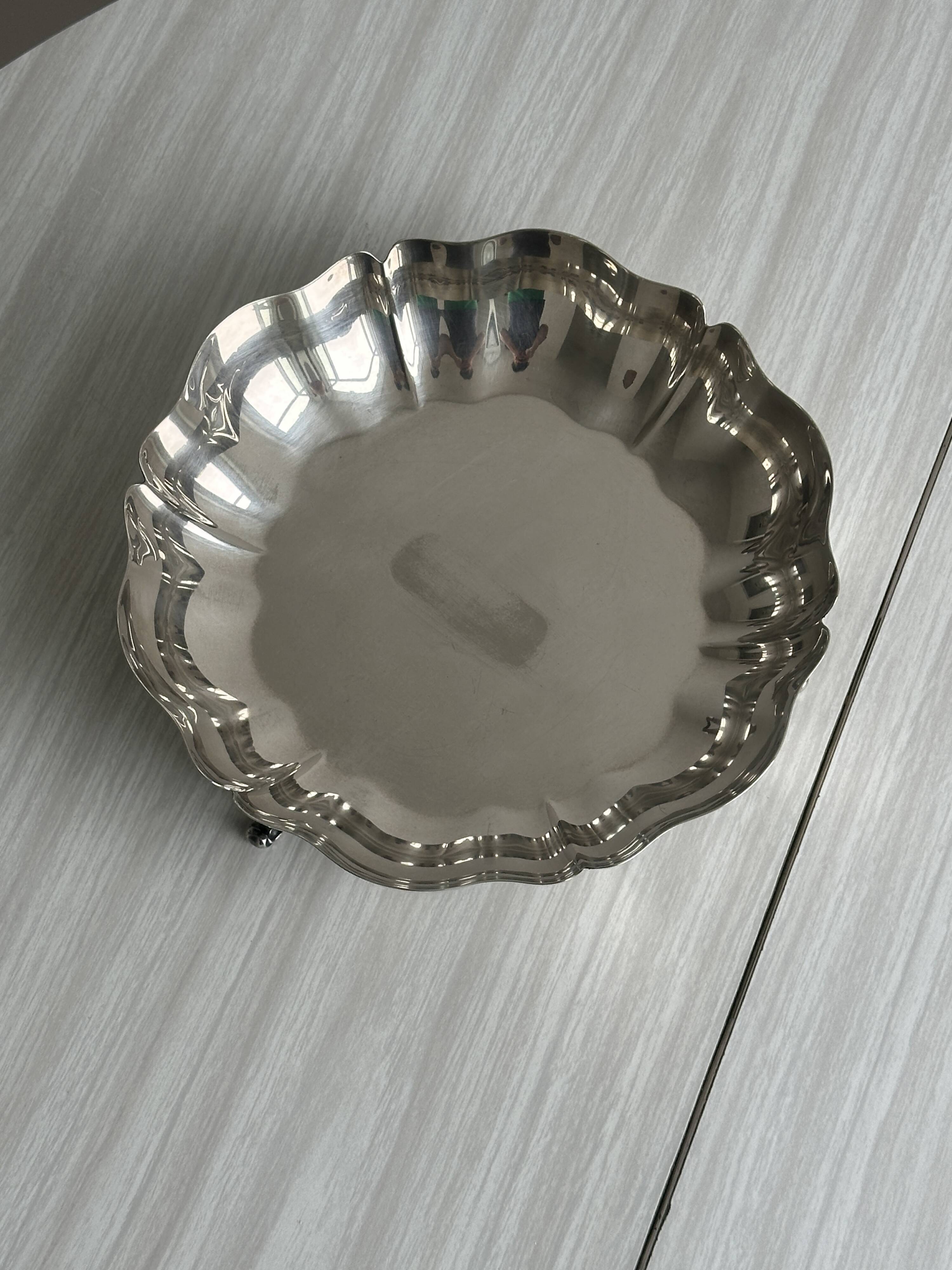 Silver-plated metal basket on rockwork feet